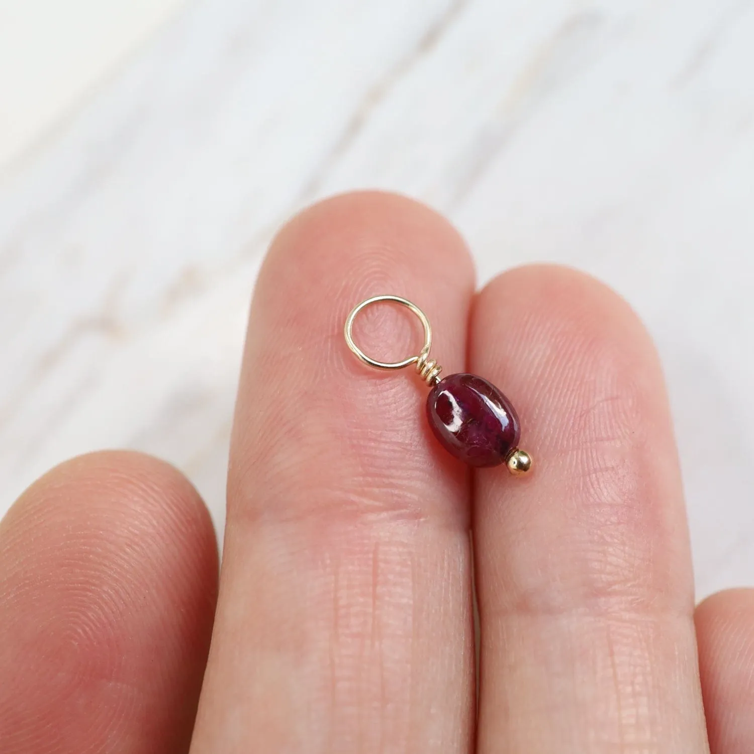 Ruby Unfaceted Oval Gemstone Charm